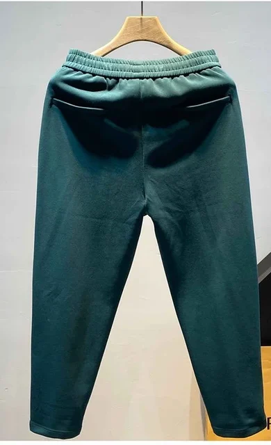 "Pair of stylish green trousers displayed on a neutral background, featuring a tailored fit and sleek design. The trousers are made from high-quality fabric, showcasing a vibrant green shade that adds a pop of color to any outfit. Ideal for both casual and formal occasions."