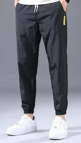 A pair of premium black cotton sweatpants featuring a relaxed fit and elastic waistband. Made from soft, breathable fabric, these sweatpants offer a sleek black color that adds a touch of sophistication to casual outfits. Ideal for lounging, workouts, or everyday wear, they combine comfort and style effortlessly.