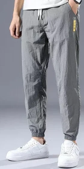 A pair of soft light grey sweatpants featuring a relaxed fit and elastic waistband. Made from cozy, breathable fabric, these sweatpants offer a neutral tone that easily complements various tops. Ideal for lounging at home, working out, or running errands, they combine style and comfort effortlessly.