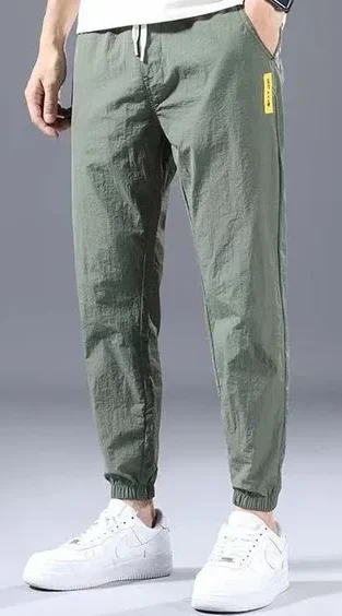 A pair of trendy green sweatpants featuring a relaxed fit and elastic waistband. Made from soft, breathable fabric, these sweatpants showcase a vibrant green color that adds a pop of personality to casual outfits. Perfect for lounging, workouts, or running errands, they combine comfort and style effortlessly.