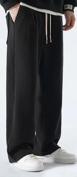 A pair of classic black trousers with a tailored fit, featuring a mid-rise waist and a straight-leg cut. Ideal for versatile styling, the trousers are crafted from a smooth, high-quality fabric for a polished look that works seamlessly from office settings to evening events.