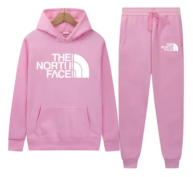 "Person confidently wearing a stylish pink tracksuit, combining a relaxed fit with trendy details. The soft pink color adds a touch of elegance and femininity, creating a look that’s both comfortable and chic."